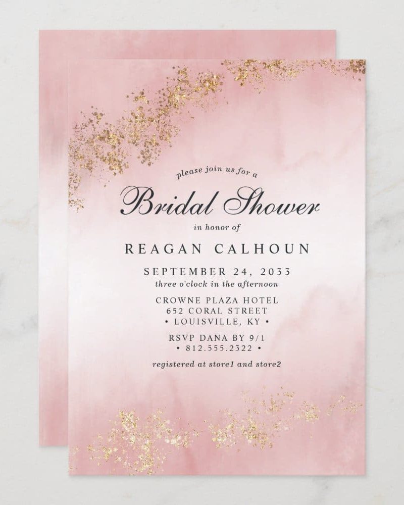 Pink bridal shower invitation with gold glitter detailing. The invitation features the name Reagan Calhoun and event details.