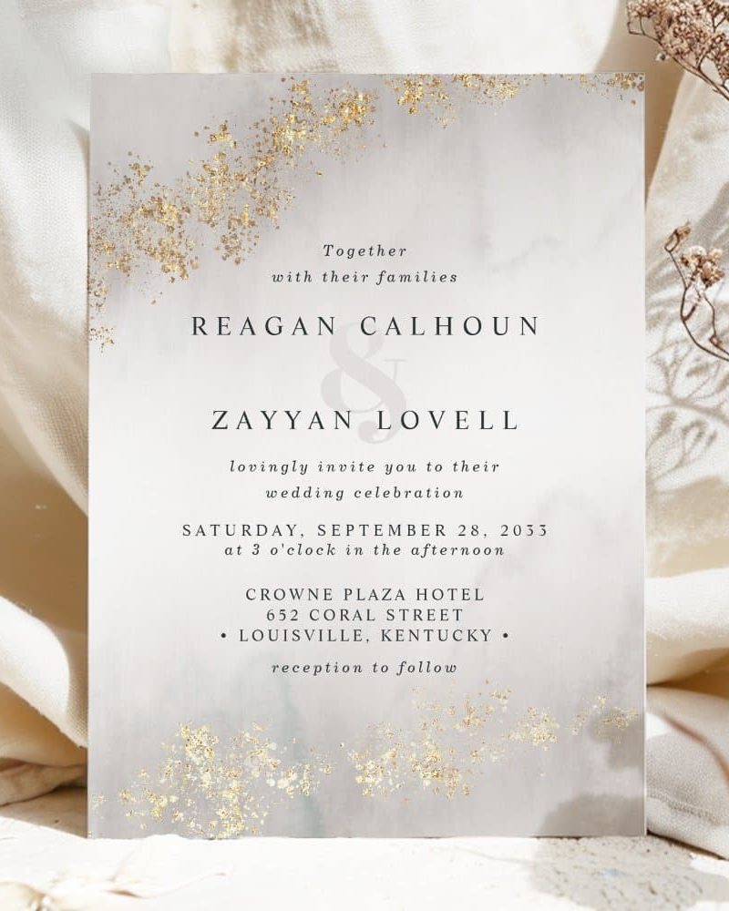 Wedding invitation for Reagan Calhoun and Zayyan Lovell, featuring gold accents on a gray background.
