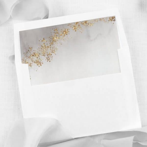 White Envelope With A Gray And Gold Insert.