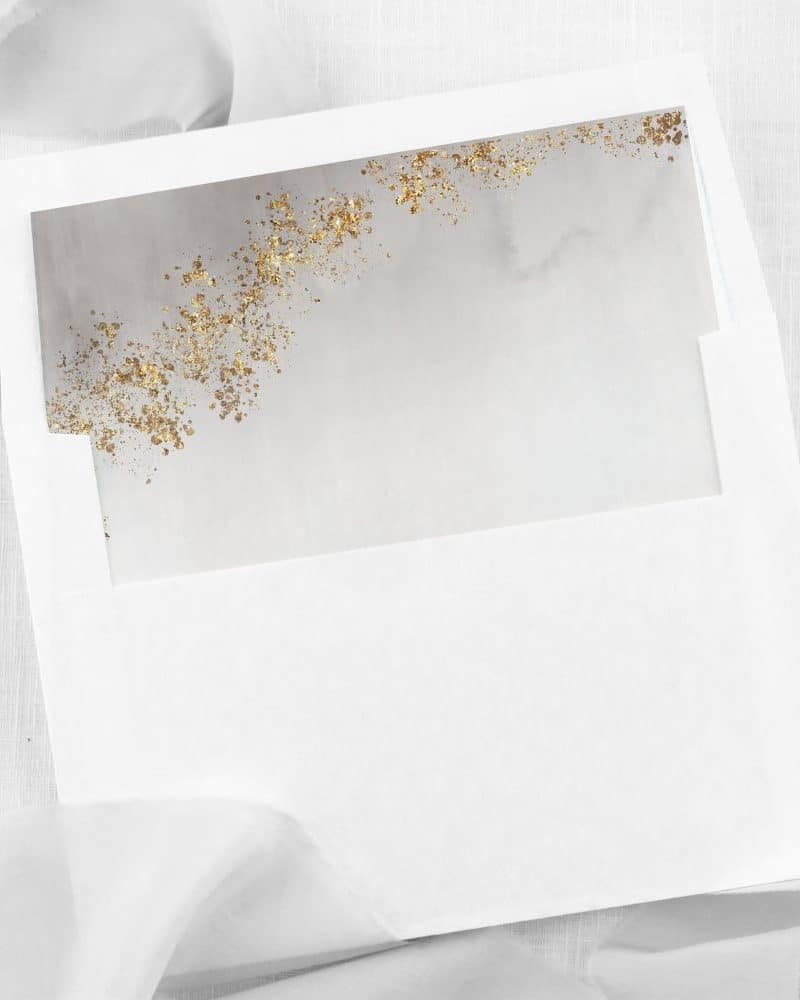 White envelope with a gray and gold insert.