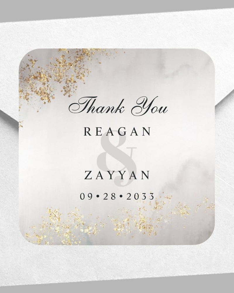 Square wedding thank you sticker with marble background, gold glitter accents, and the names Reagan & Zayyan and wedding date 09.28.2033.