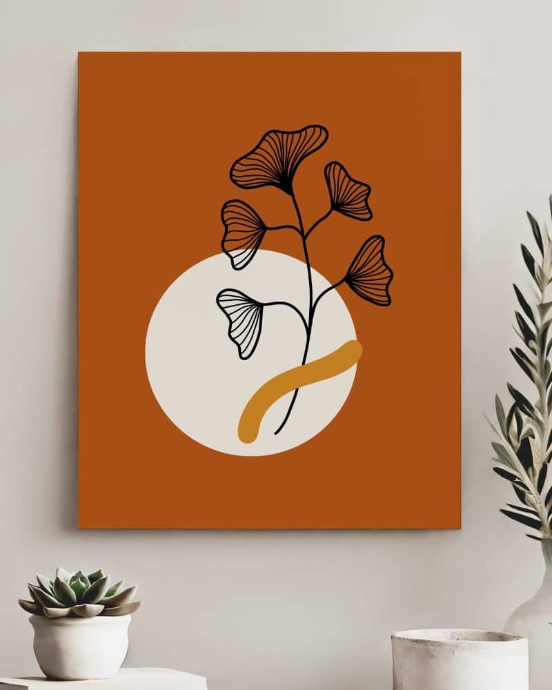 Abstract art print of a stylized floral branch with ginkgo-like leaves, in black and off-white, set against a burnt orange background and a beige circle.