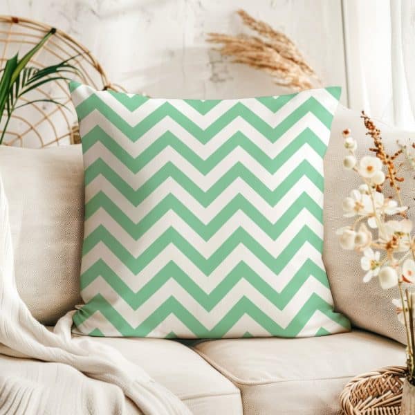 Light Green And White Chevron Patterned Throw Pillow On A Beige Couch.
