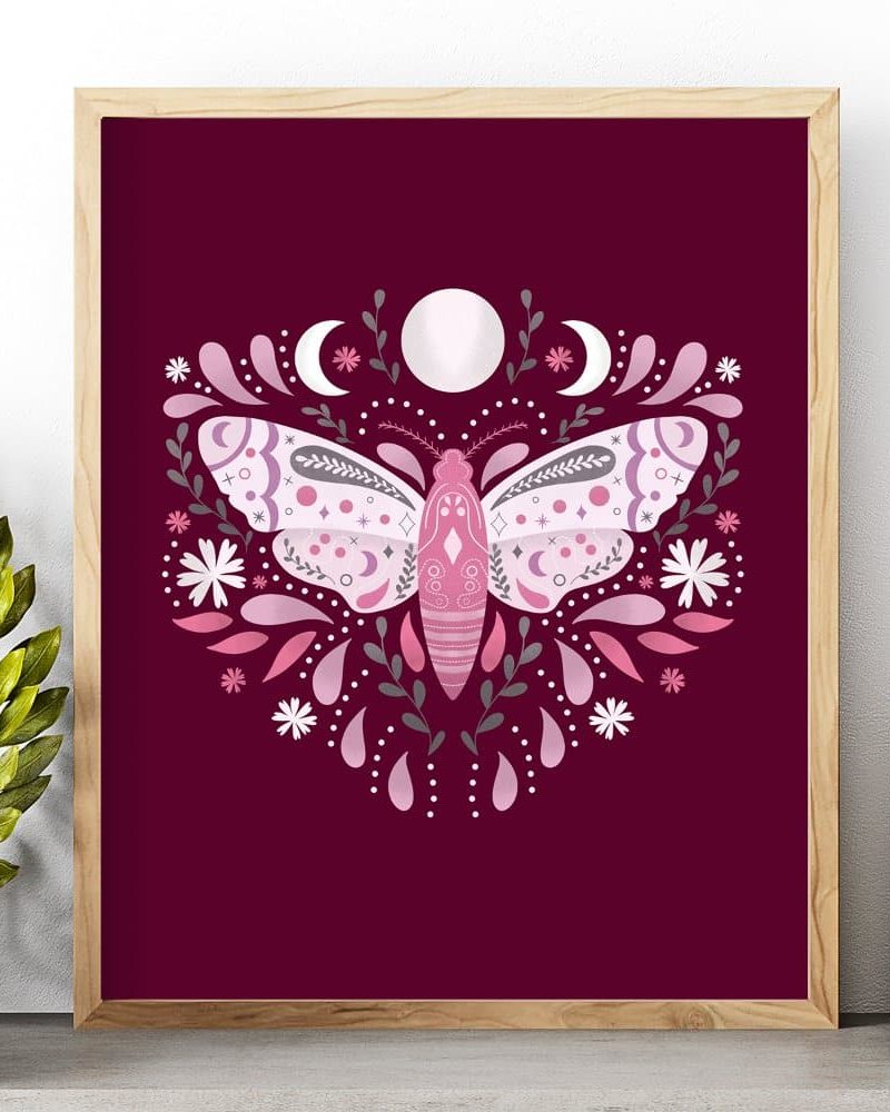Framed illustration of a pink moth surrounded by flowers and crescent moons on a burgundy background.