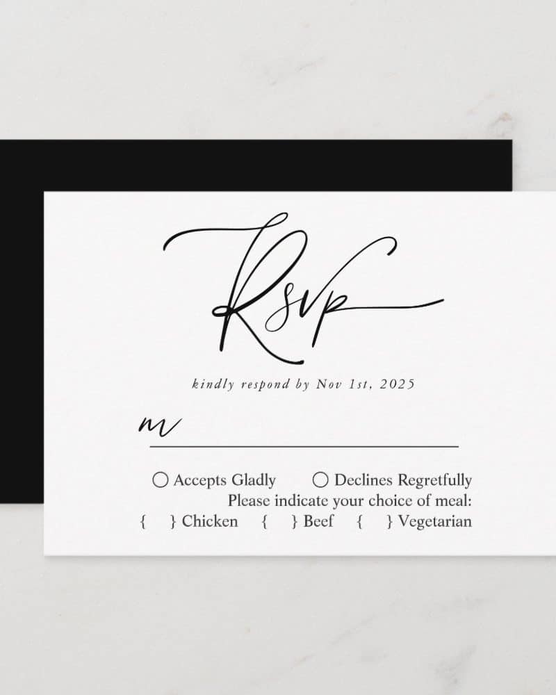 White RSVP card with black script lettering and response options including meal choices.