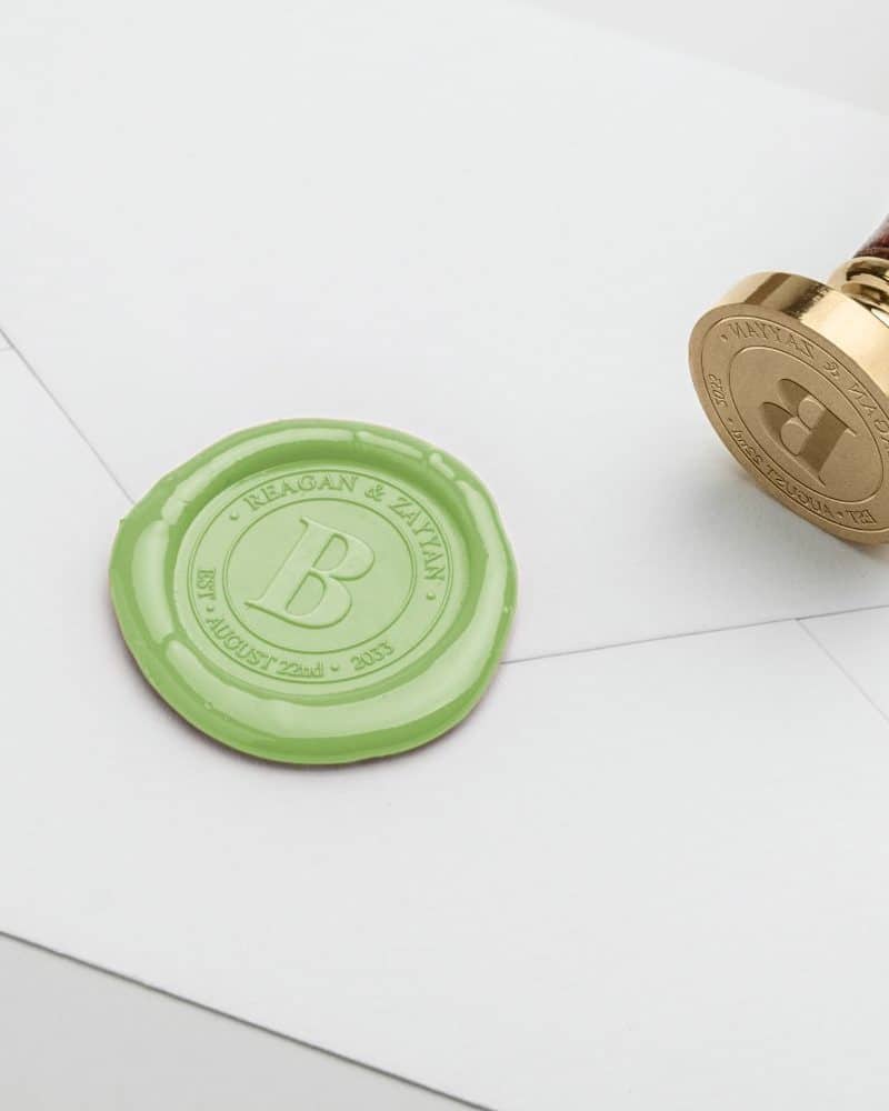 Light green wax seal with the initials B, Reagan & Zayyan, and the date August 22nd, 2035.