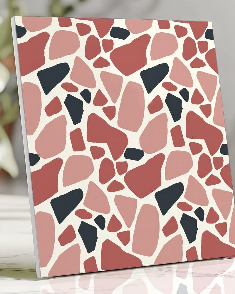 Abstract terrazzo print in pink, red, and dark gray.