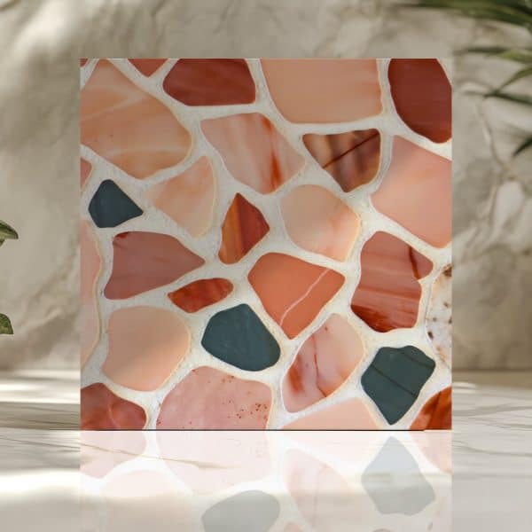 Square Mosaic Tile With Peach, Terracotta, And Dark Green Irregularly Shaped Pieces.