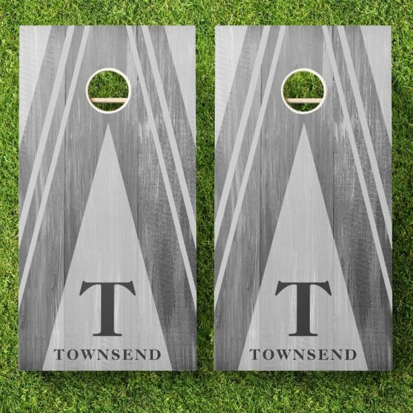 Pair Of Gray Wooden Cornhole Boards With A Gray And White Geometric Design, The Letter T, And The Name Townsend.