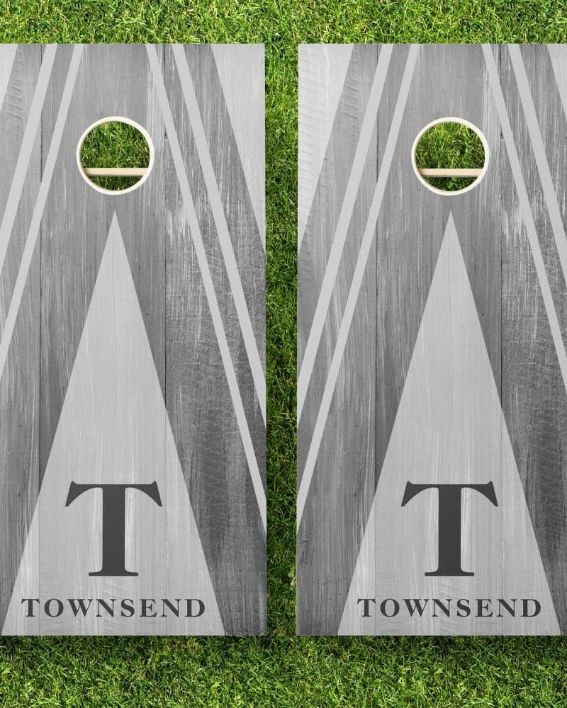 Pair of gray wooden cornhole boards with a gray and white geometric design, the letter T, and the name Townsend.
