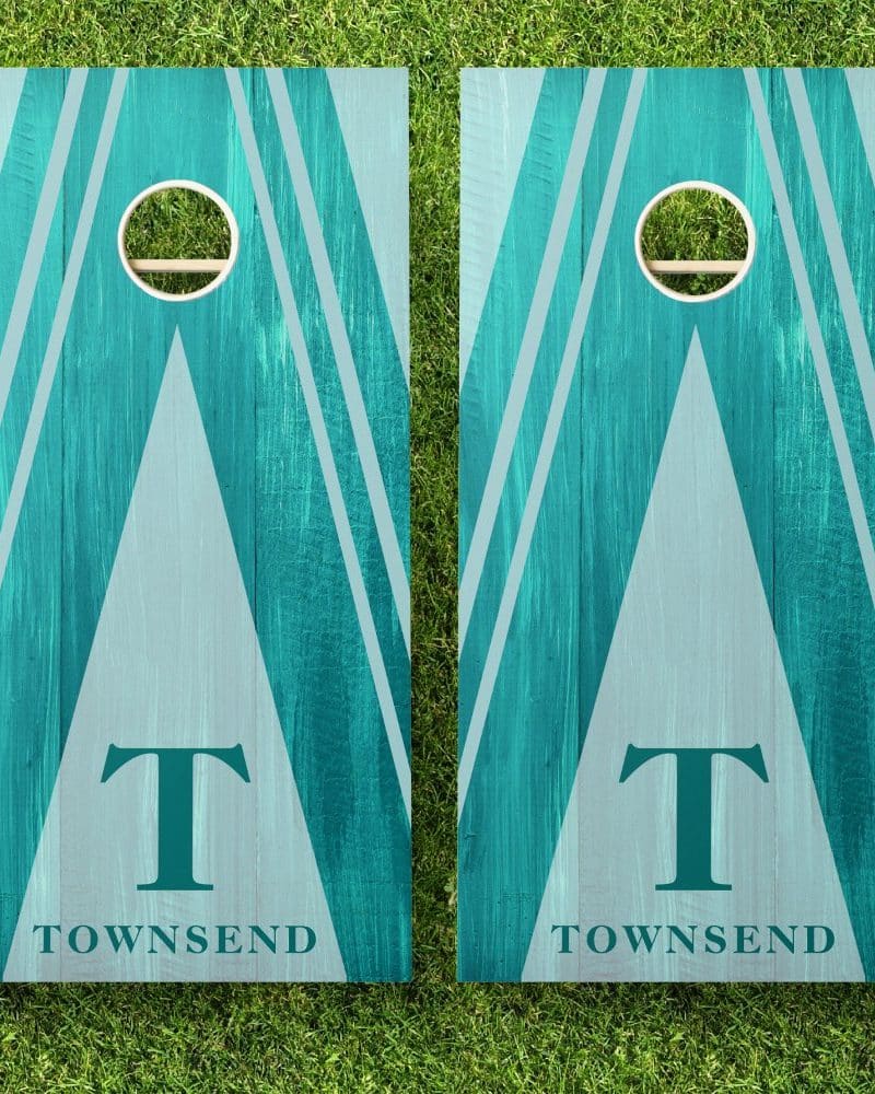 Pair of teal and gray wooden cornhole boards with the initial T and the name Townsend.