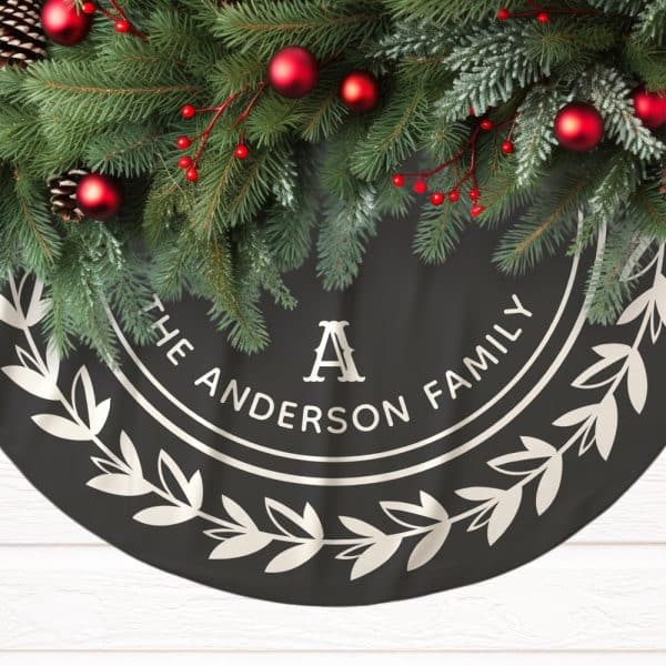 Black Christmas Tree Skirt With A Silver Wreath Design And The Words The Anderson Family In A Circle.