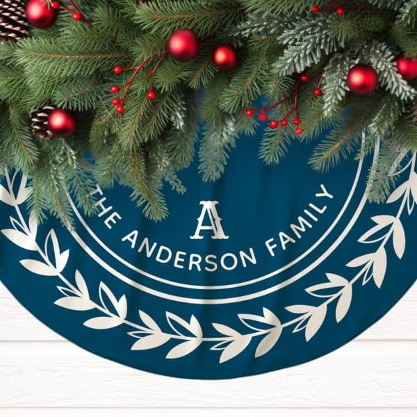 Teal Christmas Tree Skirt With The Anderson Family Name And Initial A In A Circular Design, Adorned With A Garland Of Evergreen Branches And Red Ornaments.