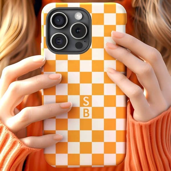 Hands Holding An Orange And White Checkered Phone Case.