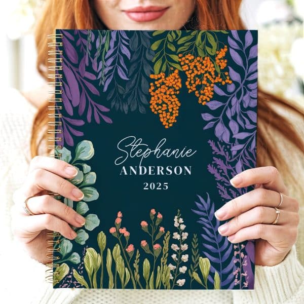 A 2025 Spiral-Bound Planner With A Dark Teal Cover Featuring A Floral Design And The Name Stephanie Anderson.