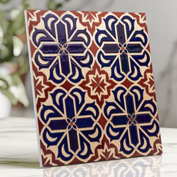 Ornate Square Tile With A Repeating Blue, Red, And Beige Floral Pattern.