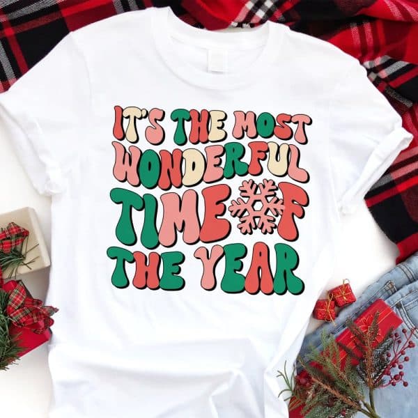 White T-Shirt With The Text Its The Most Wonderful Time Of The Year In Retro Style Lettering And A Snowflake.