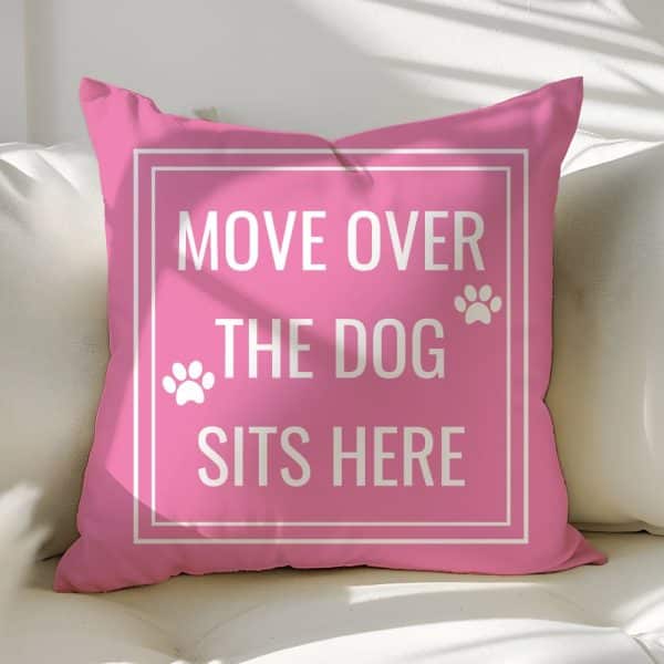 Pink Pillow With The Text Move Over The Dog Sits Here. Paw Prints Flank The Text.