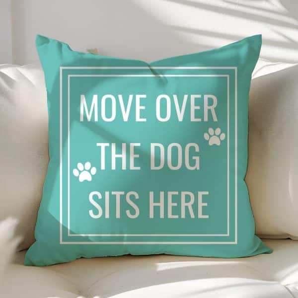 Teal Throw Pillow With White Text Reading Move Over The Dog Sits Here And Paw Prints.