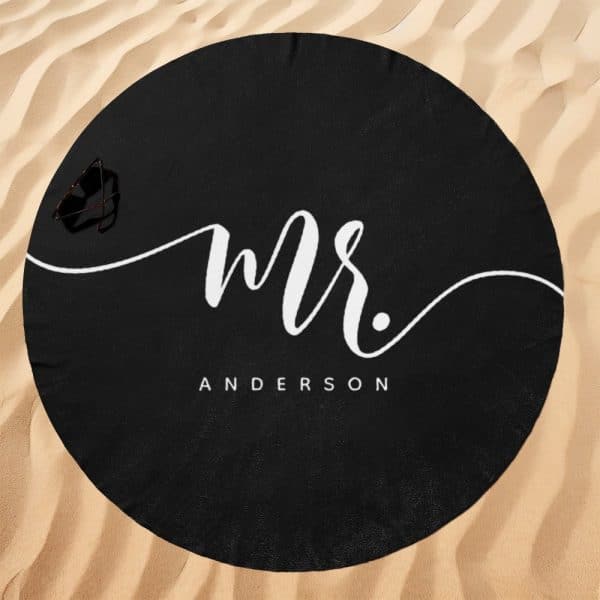 Black Round Beach Towel With The Word Mr. Anderson In Stylized White Lettering.