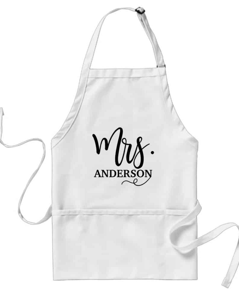 White apron with black text reading Mrs. Anderson.