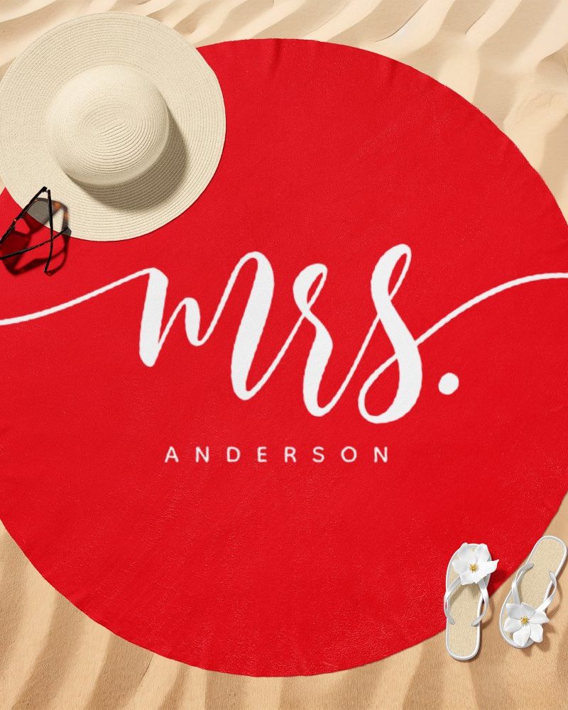 Red round beach towel with Mrs. Anderson in white script.