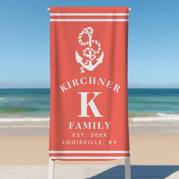 Coral Beach Towel With A White Anchor, The Letter K, And The Kirchener Family Name.