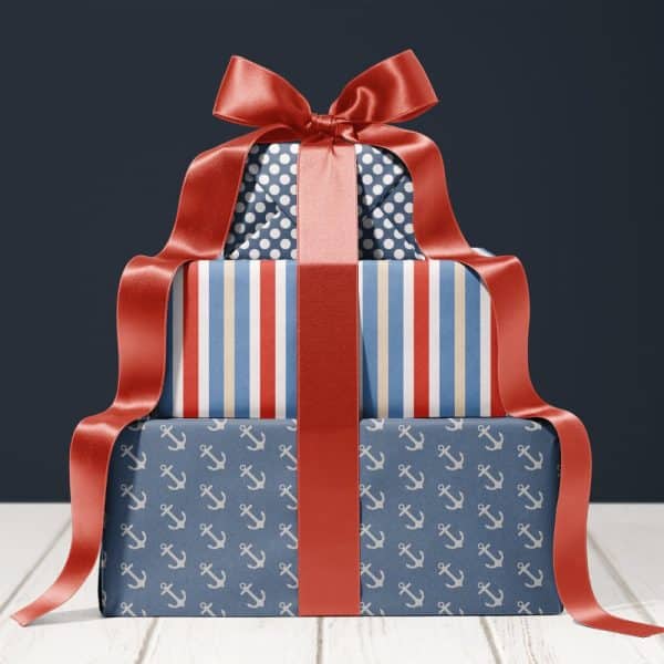 Stack Of Three Nautical-Themed Gifts Tied With A Large Red Ribbon.