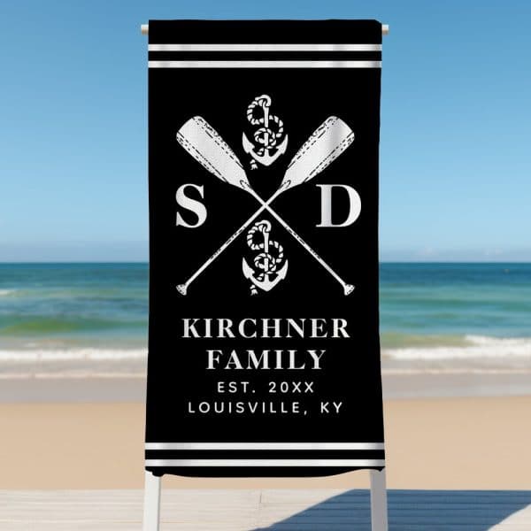 Black Beach Towel With White Crossed Oars, Anchor, And Kirchner Family Name.