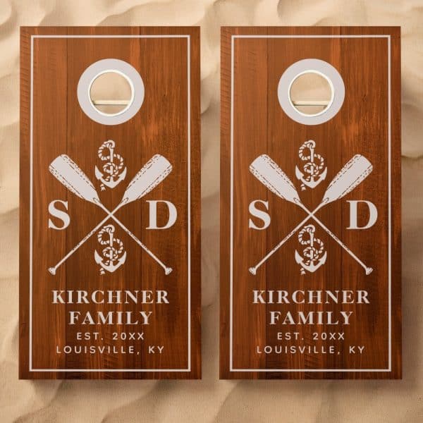 Pair Of Wooden Cornhole Boards With A Nautical Theme, Featuring Crossed Oars, An Anchor, And The Kirchner Family Name And Location.