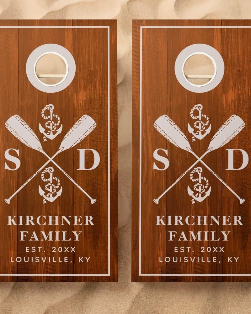 Pair of wooden cornhole boards with a nautical theme, featuring crossed oars, an anchor, and the Kirchner family name and location.