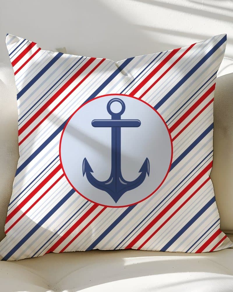 Throw pillow with a nautical theme; red, white, and blue diagonal stripes and a navy blue anchor in a light blue circle.