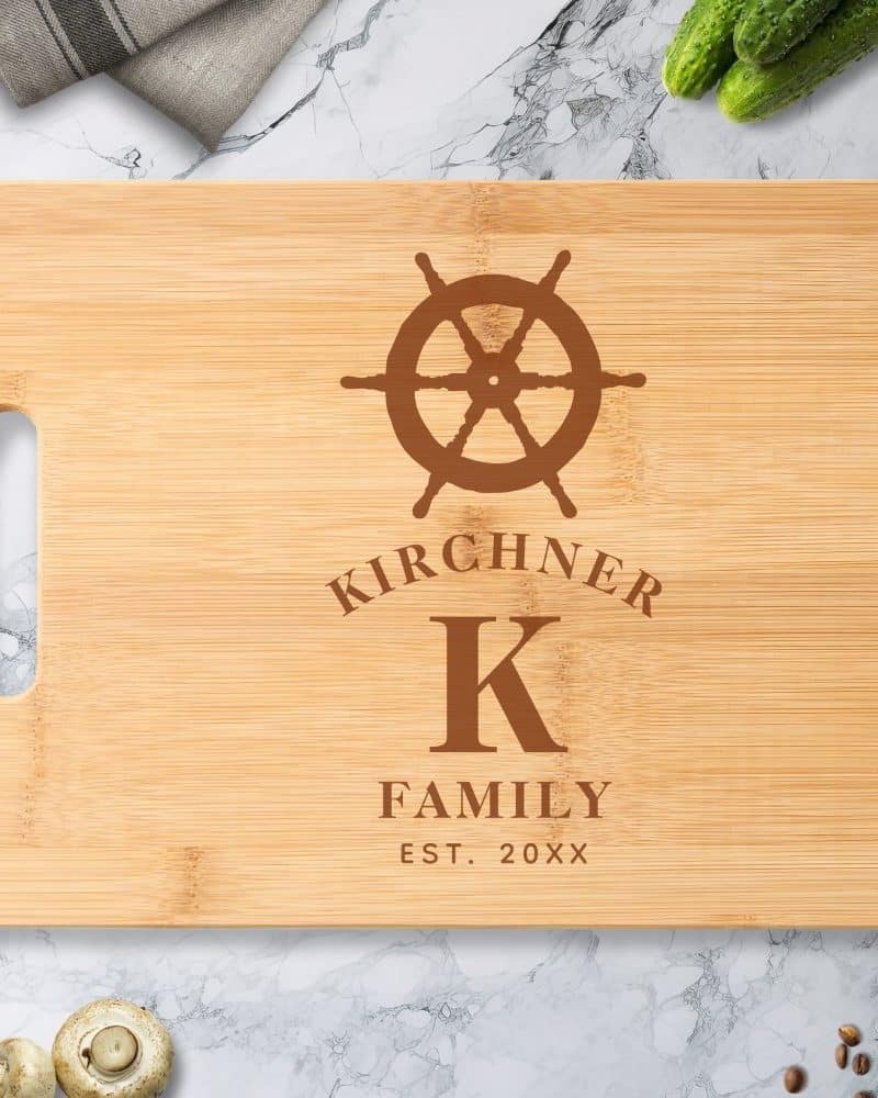 Personalized bamboo cutting board with a ship's wheel design, the letter K, and the Kirchiner Family name.