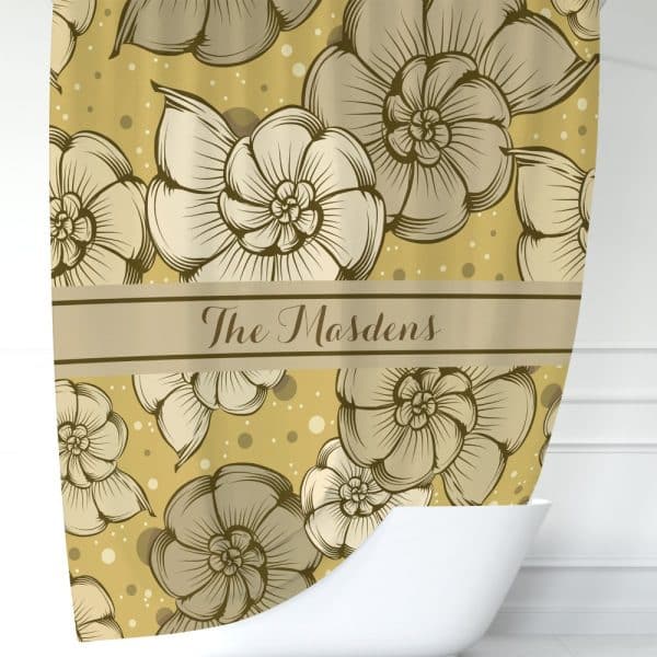 A Gold Shower Curtain With A Repeating Pattern Of Stylized Flowers And The Name The Madsens.