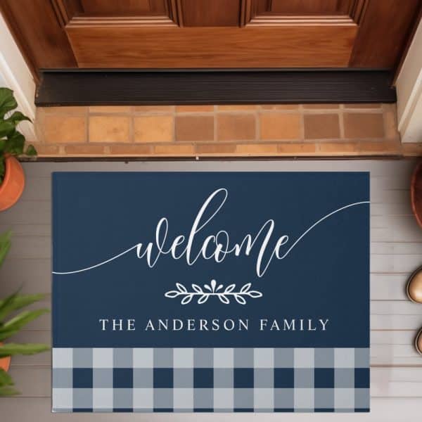 Navy Blue Welcome Mat With White Script Lettering That Says Welcome, The Anderson Family, And A Bottom Border Of Blue And Gray Gingham.