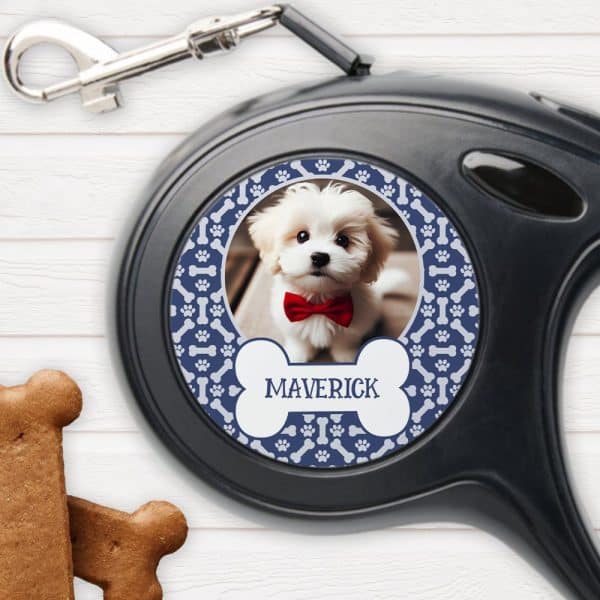 A Retractable Dog Leash With A Personalized Design Featuring A Photo Of A Small White Dog Wearing A Red Bow Tie. The Dogs Name, Maverick, Is Printed On The Leash.