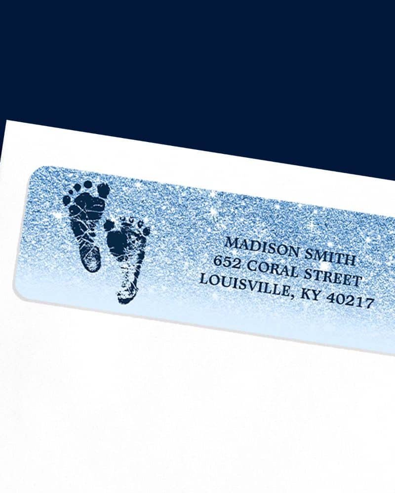 Baby shower return address label with blue glitter background and two baby footprints.