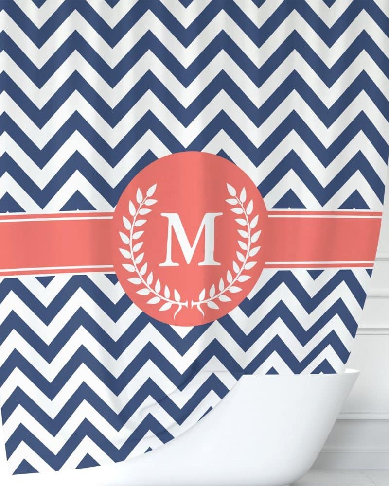 Navy blue and white chevron shower curtain with a coral monogram featuring the letter M.