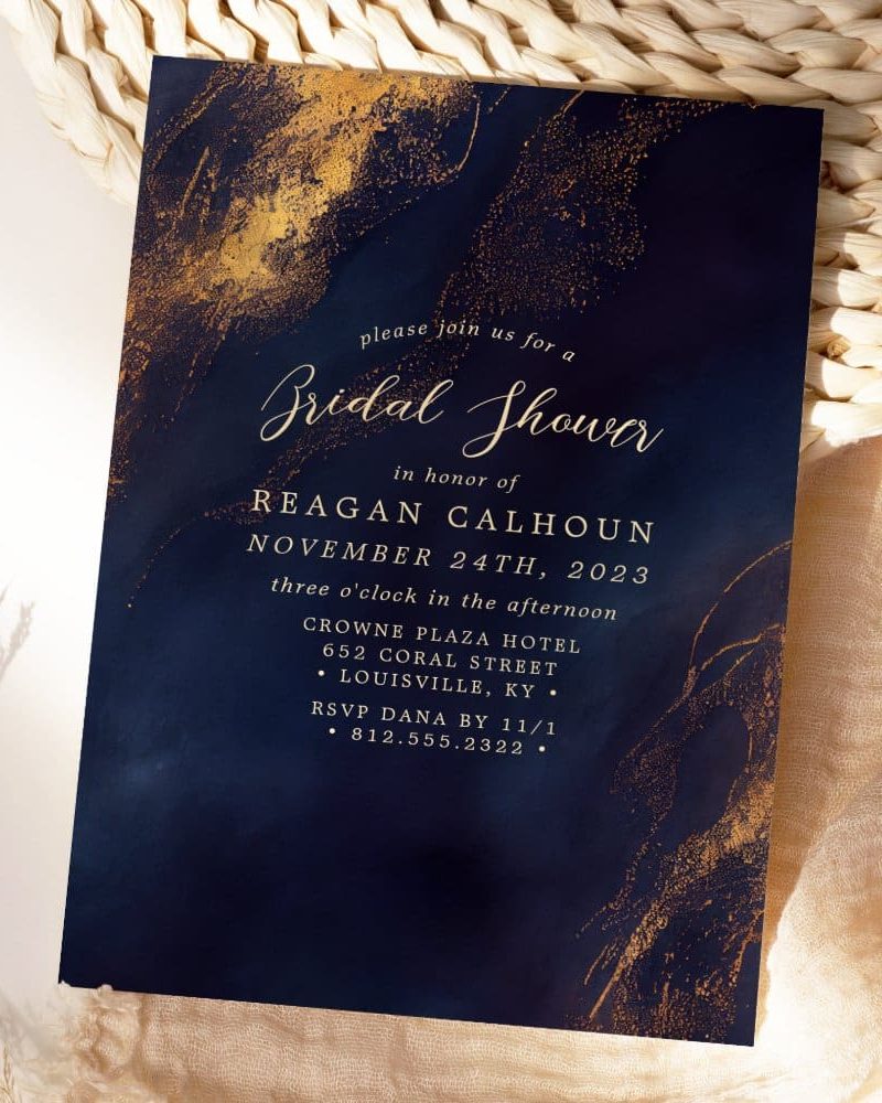 Navy blue and gold bridal shower invitation with gold paint splatter design.