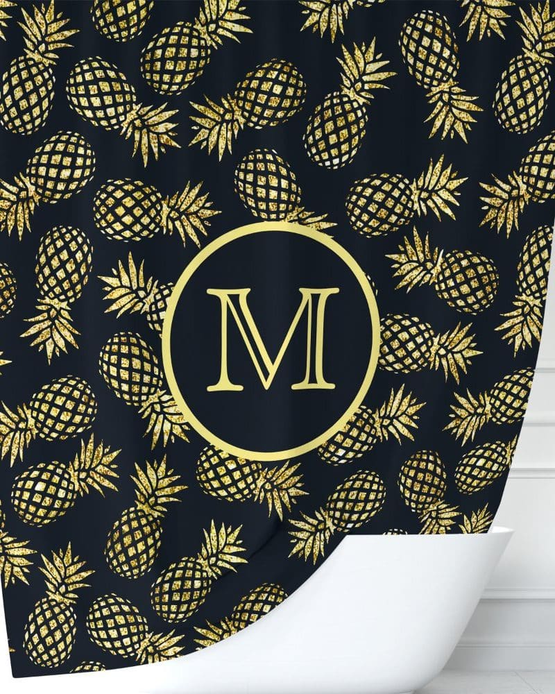 Gold glitter pineapples on a dark background shower curtain with a gold circle and the letter M in the center.