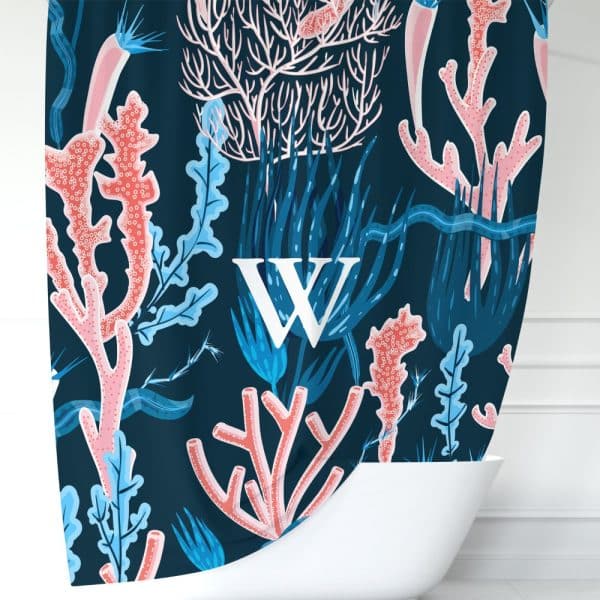 A Dark Blue Shower Curtain Featuring A Stylized Coral Reef Pattern With Pink And Blue Coral, Seaweed, And The Letter W.