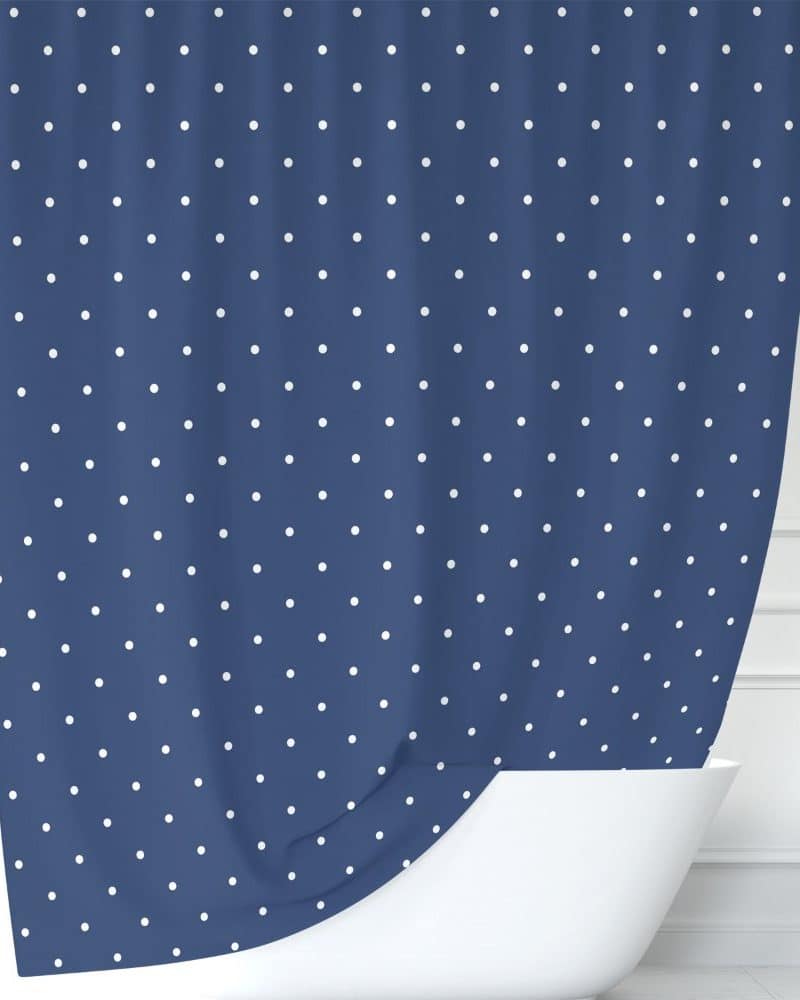 Navy blue shower curtain with white polka dots.