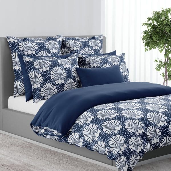 Navy Blue Duvet Cover And Shams With A White Seashell Pattern.