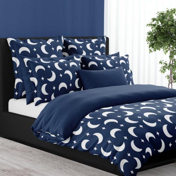 Navy Blue Duvet Cover And Pillow Shams With A White Crescent Moon And Star Pattern.