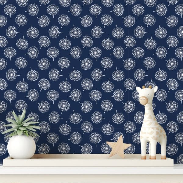 A Shelf Displays A White Giraffe Toy And A Small Potted Plant In Front Of A Dark Blue Wall Featuring A Repeating Pattern Of White Dandelions.