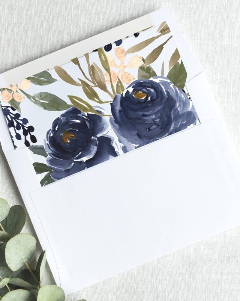 White envelope with a navy blue floral insert.