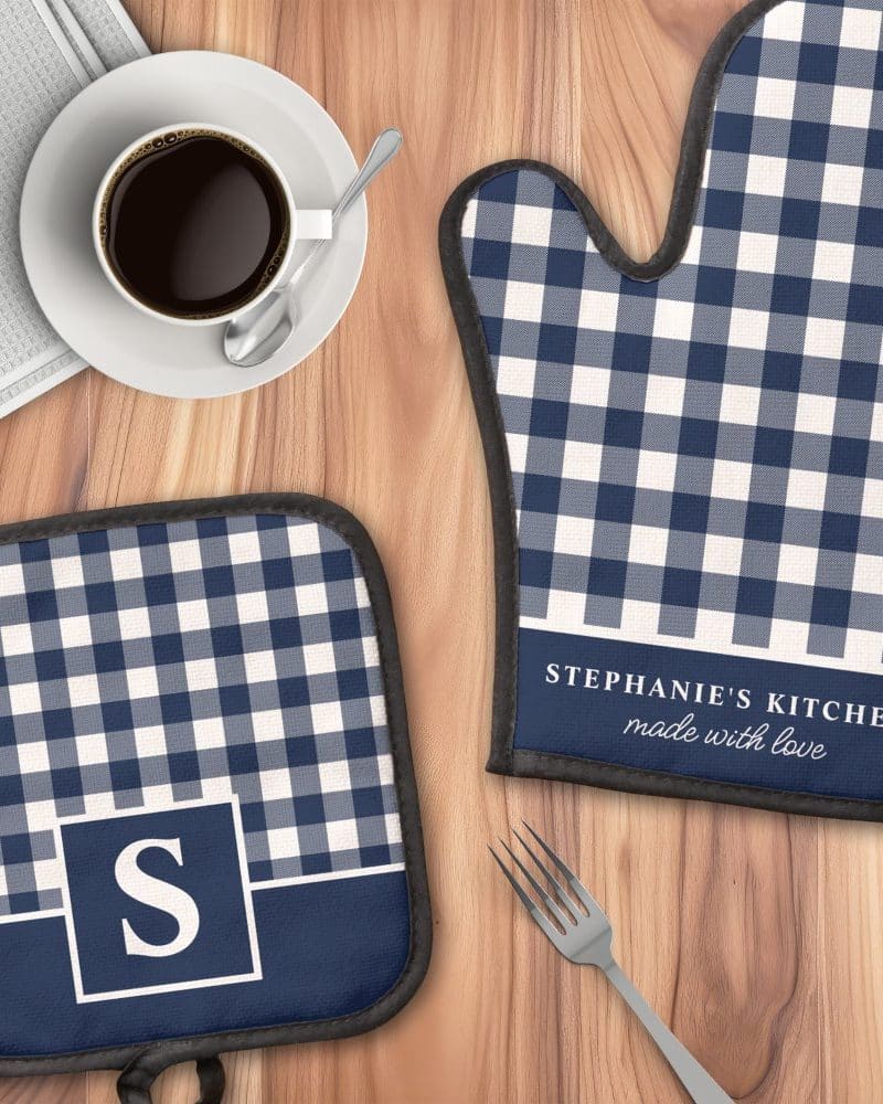 Navy blue and white gingham oven mitt and pot holder set, personalized with the initial S and the words Stephanie's Kitchen made with love.
