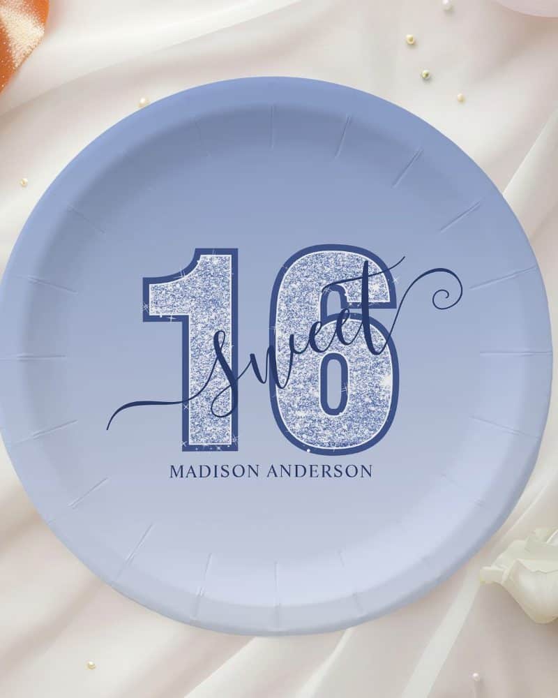 Periwinkle blue paper plate with glitter-textured number sixteen and the word Sweet; personalized with Madison Anderson.