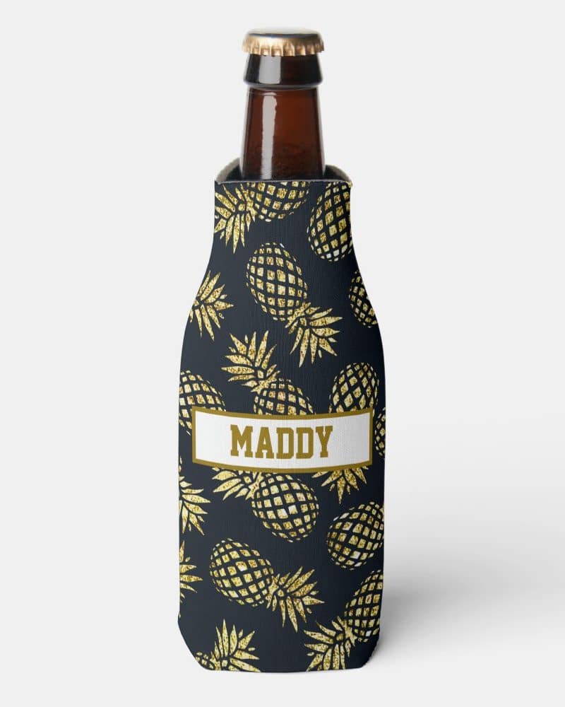 Bottle koozie with a dark background and gold glitter pineapples; personalized with the name Maddy.