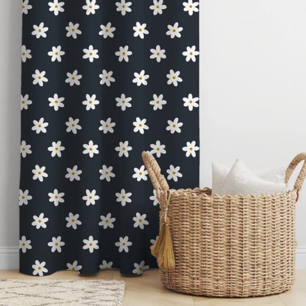 Dark Navy Blue Curtain With A Repeating Pattern Of White Daisies, Next To A Wicker Basket Containing White Pillows.